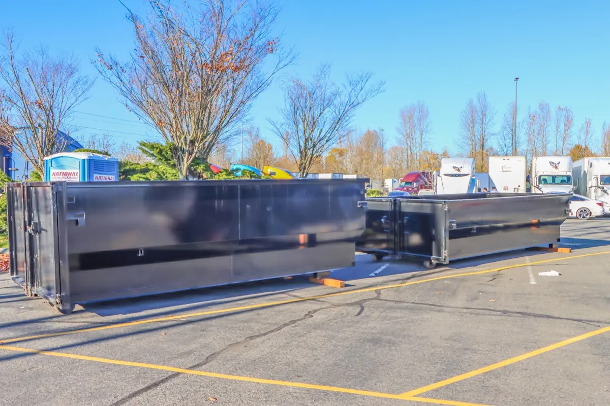 Professional dumpster rental service with roll-off container on residential driveway in Lamesa
